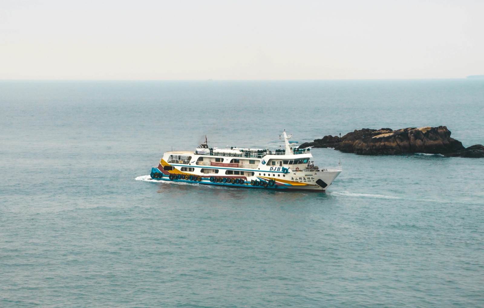 Motorcycle being loaded onto a wooden ferry crossing in Konkan coast motorcycle route